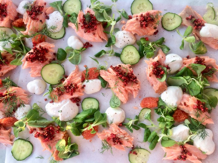 Hot smoked salmon with pink peppercorn, cucumber and sour cream