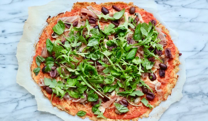 Gluten free pizza with home made tomato sauce, air-dried ham and mozzarella