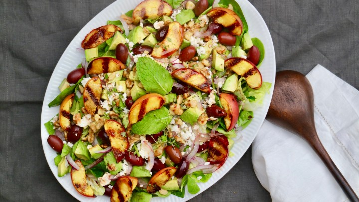 Green salad with grilled peaches, walnuts and olives