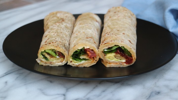 Norwegian flatbread (Lefse) with avocado, sun-dried tomatoes and spinach