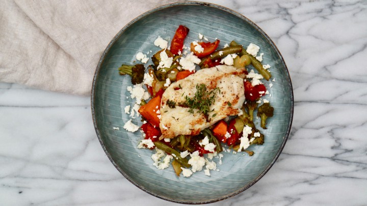 Fried Sheepshead fish on a green and red salad with Feta cheese