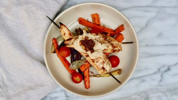 Grilled chicken skewers with summer vegetables and hummus