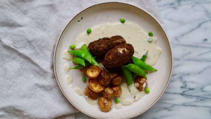 Filled Beef Croquette with grilled potatoes, sugar snap peas and a creamy sauce